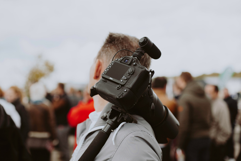  Man carrying a camera over his shoulder